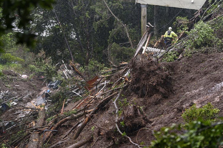 Rescue workers sift through debris after a mudslide that destroyed three homes on a hillside in Sausalito, Calif., Feb. 14, 2019, during an atmospheric river storm. AP Photo/Michael Short