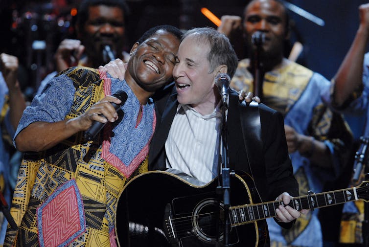 Joseph Shabalala beams during a Washington performance with Paul Simon in 2007. Scott Suchman/WireImage