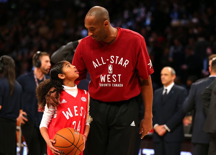 Gigi Bryant, looking up to her dad on the court in 2016. Elsa/Getty Images