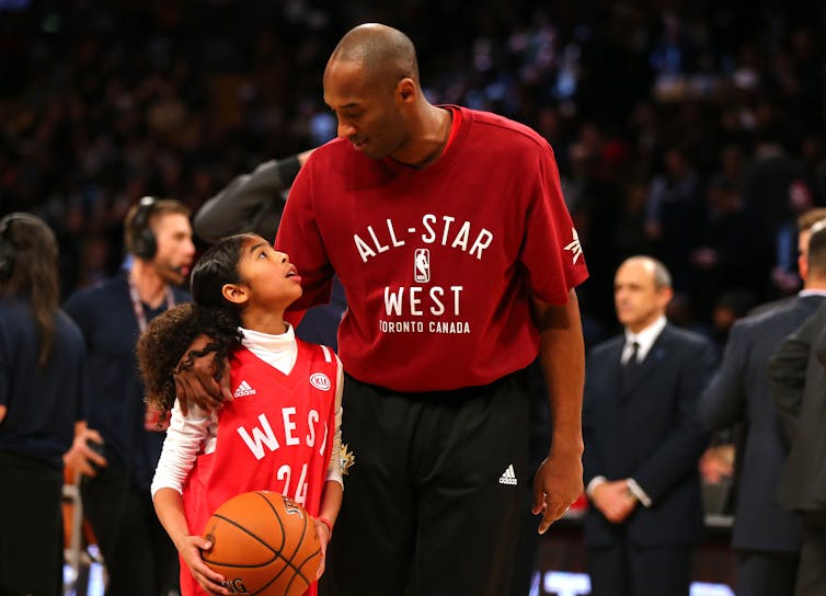 Gigi Bryant, looking up to her dad on the court in 2016. Elsa/Getty Images Gigi Bryant, looking up to her dad on the court in 2016. Elsa/Getty Images