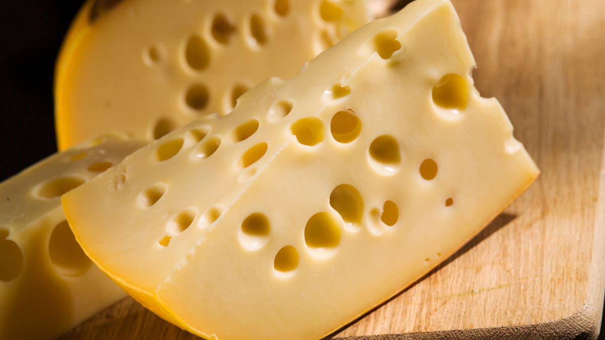 Why does Swiss cheese have holes?
