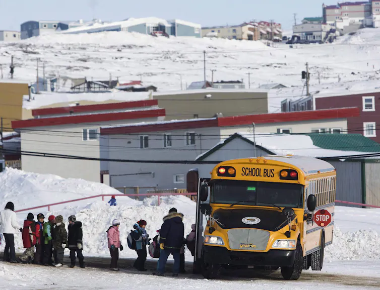 children board a schoolbus