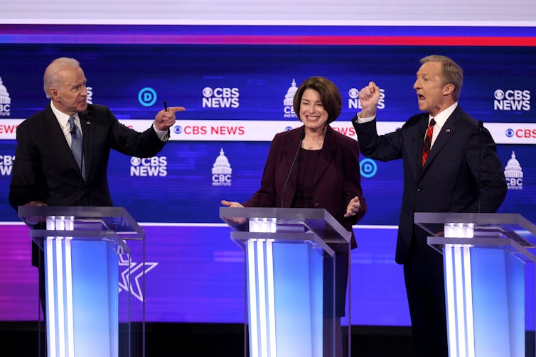 Democratic presidential candidates former Vice President Joe Biden (L) and Tom Steyer (R) debate as Sen. Amy Klobuchar (D-Minn.) reacts during the Democratic presidential primary debate, Feb. 25, 2020 in Charleston, South Carolina. Getty/Win McNamee