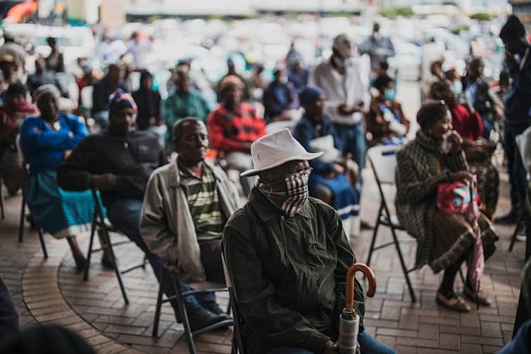 An elderly man at a social grant paypoint in South Africa after the COVID-19 lockdown. (Photo by MARCO LONGARI / AFP) () Photo by Marco Longari/AFP via Getty Images An elderly man at a social grant paypoint in South Africa after the COVID-19 lockdown. (Photo by MARCO LONGARI / AFP) () Photo by Marco Longari/AFP via Getty Images