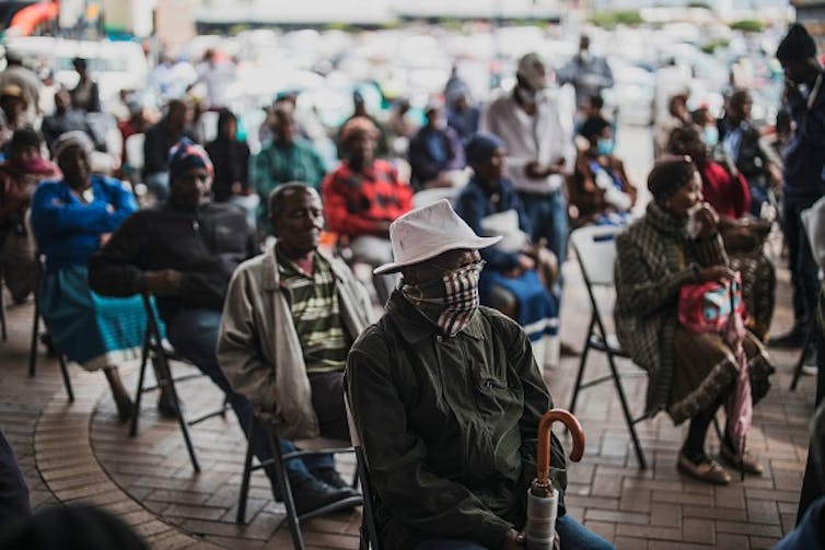 An elderly man at a social grant paypoint in South Africa after the COVID-19 lockdown. (Photo by MARCO LONGARI / AFP) () Photo by Marco Longari/AFP via Getty Images