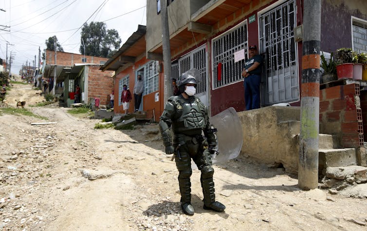 Colombians under mandatory quarantine hang red fabric out their windows to request food aid, Soacha, April 15, 2020. Leonardo Munoz/VIEWpress via Getty Images