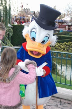 Photo of Scrooge McDuck at Disneyland signing an autograph