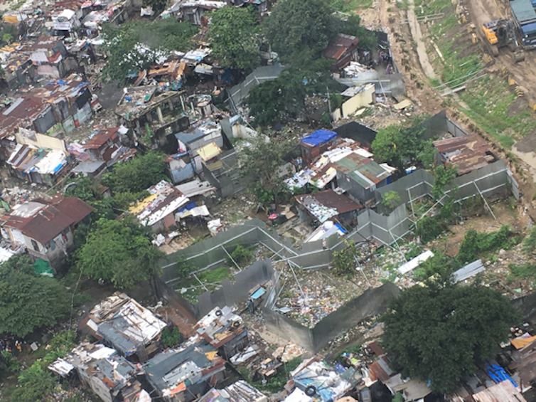 'Forced' evictions eat away at a Manila community as developer spares the golf course next door