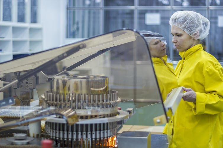 A woman working in a vaccine manufacturing plant.