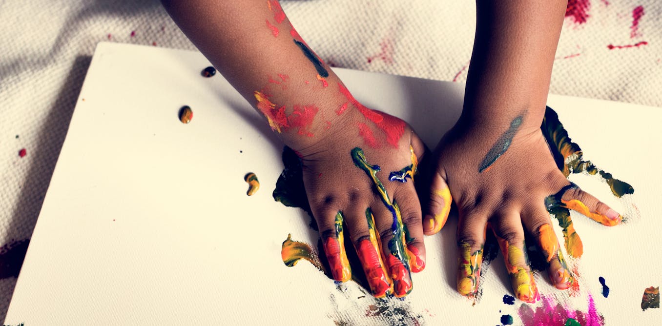 Brain research shows the arts promote mental health 'a child's hand with paint on it'