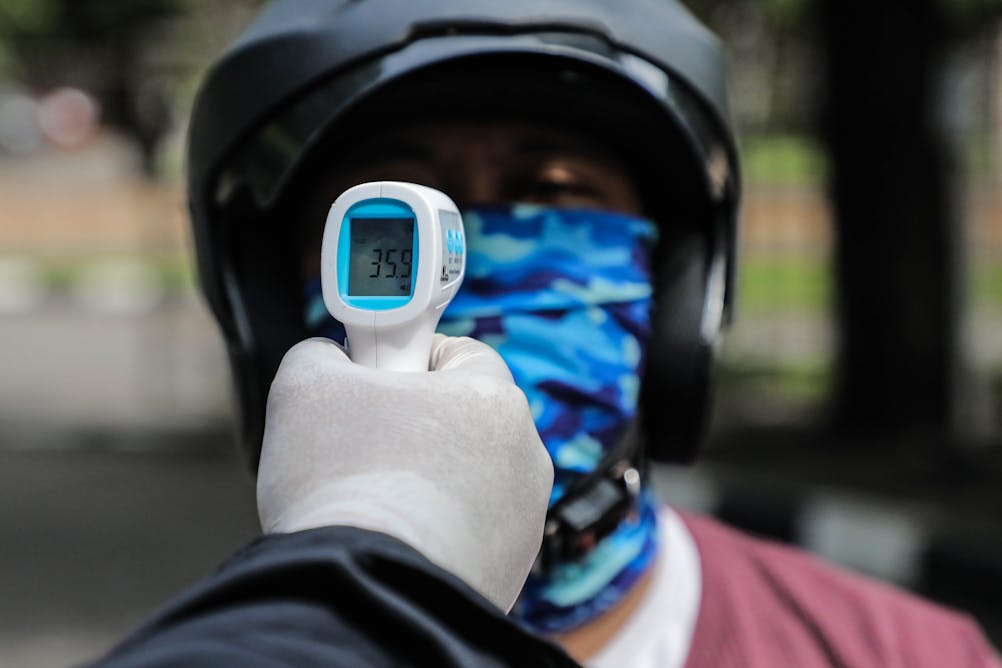 Free Photo  Medical thermometer indicating high temperature on the face  masks-coronavirus