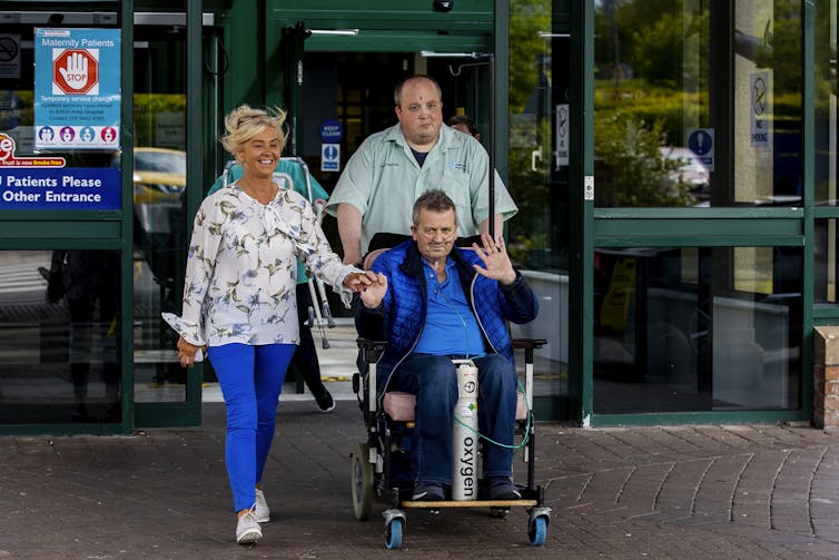 Geoffrey McKillop (front) with his partner Nicola Dallet McConaghie as they left the hospital where he was discharged after surviving coronavirus.