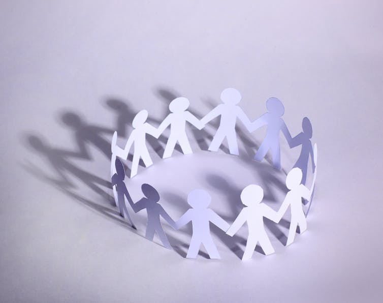 A paper chain of people in a circle.