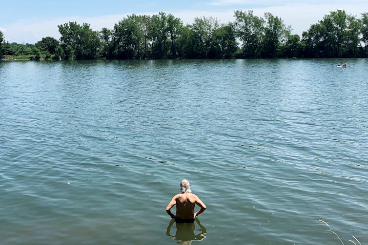 A man wading into water