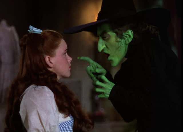 Dorothy looks up at the Wicked Witch of the West.