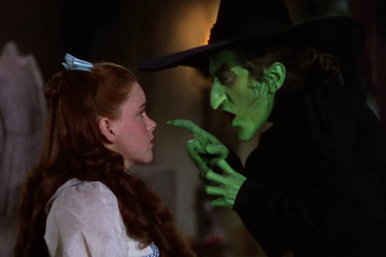 Dorothy looks up at the Wicked Witch of the West.