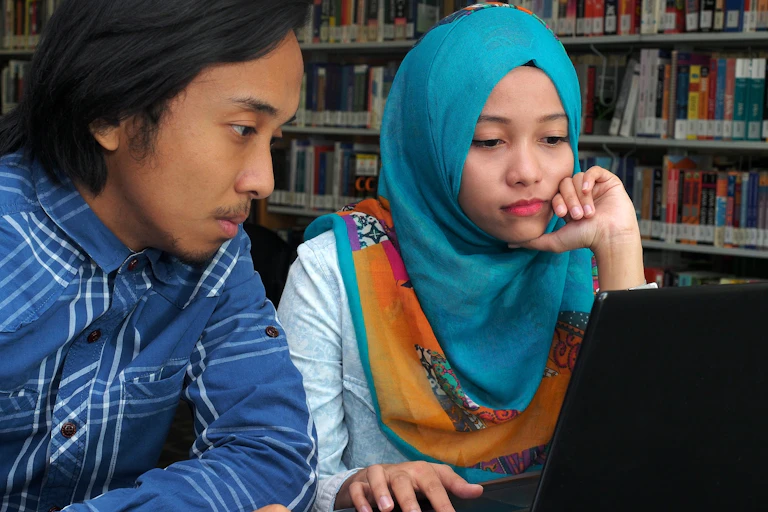Two students in a library.