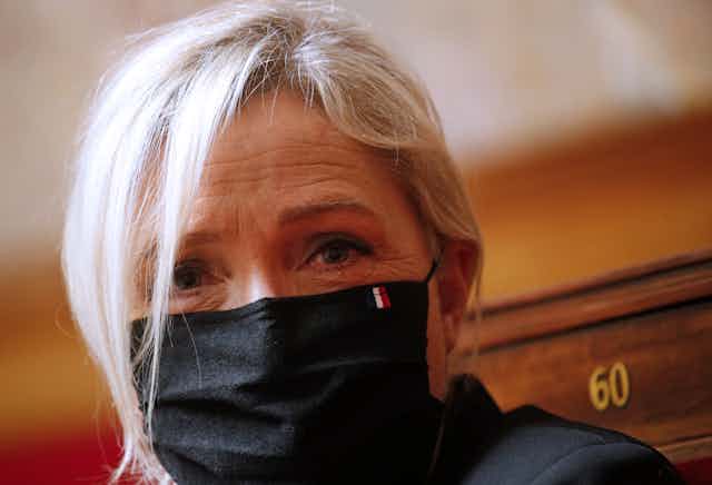Marine Le Pen wears a mask in parliament.