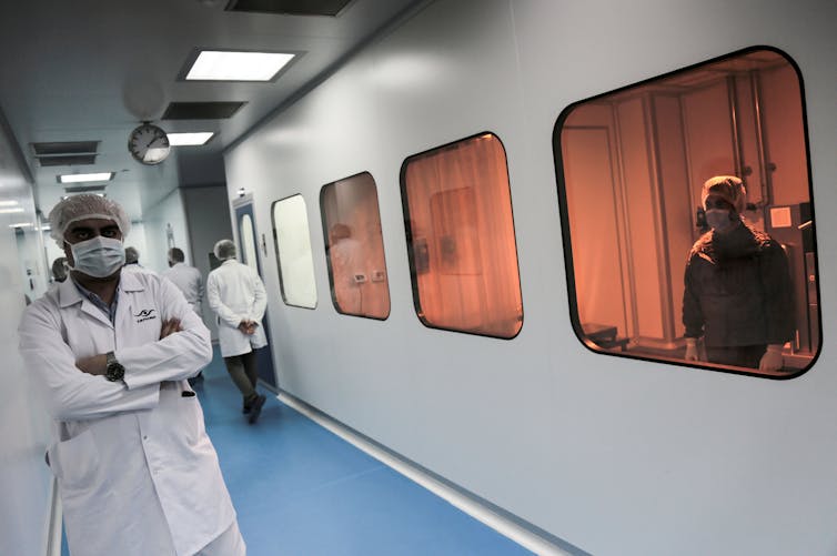 Masked health workers at a pharmaceutical manufacturing company