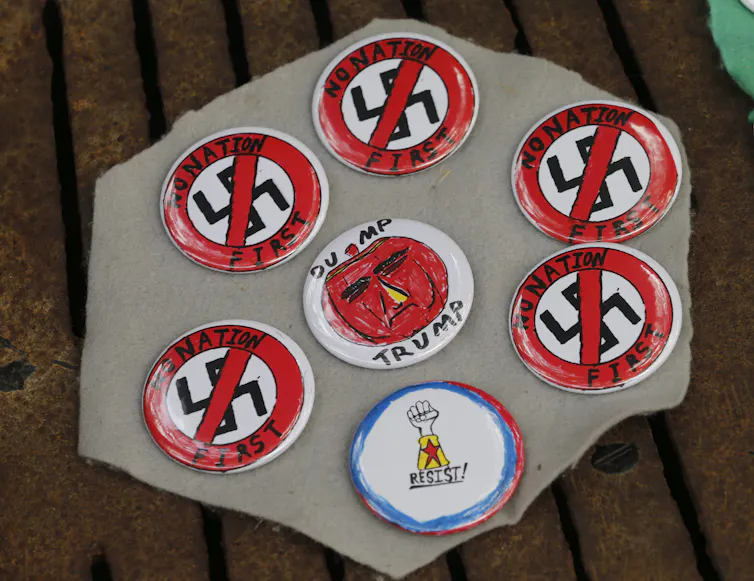 A vendor displays anti-racism buttons in Charlottesville, Va., in August 2018.