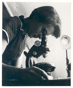 Woman looking into microscope