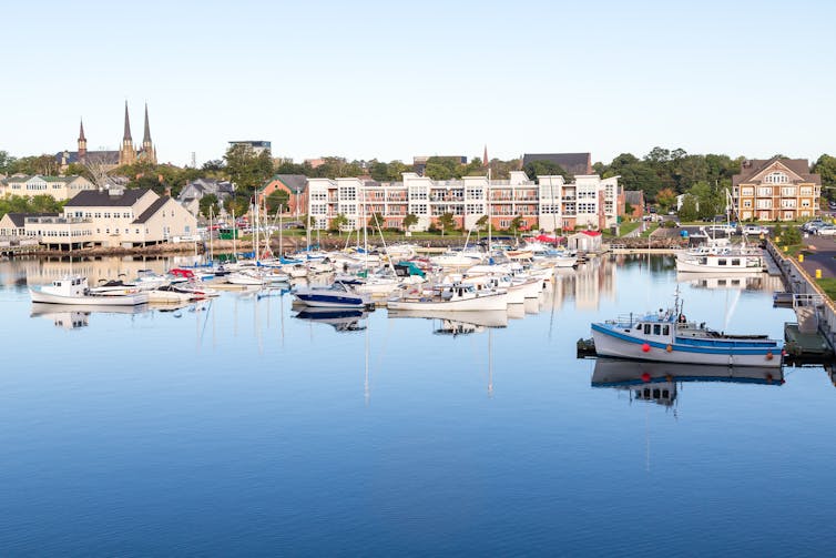 Small fishing boats in a calm blue harbour on Prince Edward Island.