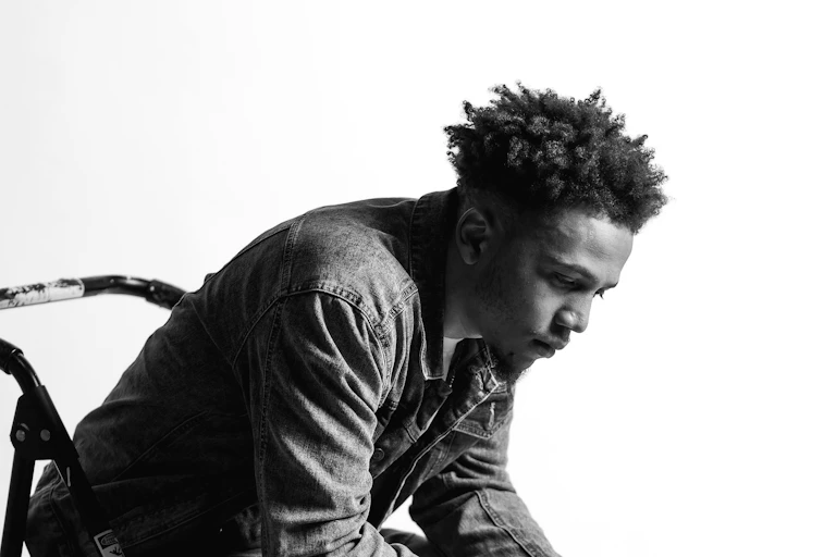 Young Black man sitting alone looking sad