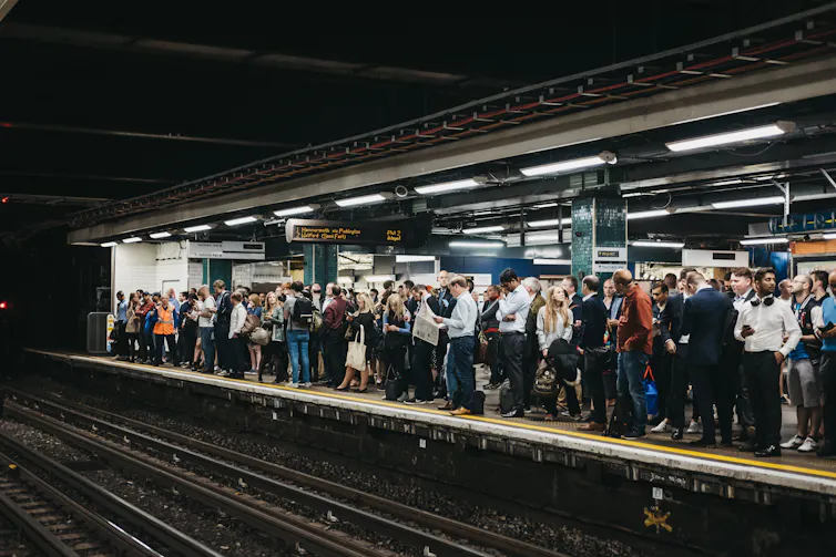 Busy train platform during London commute.