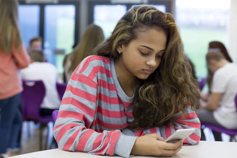 Student alone with smartphone