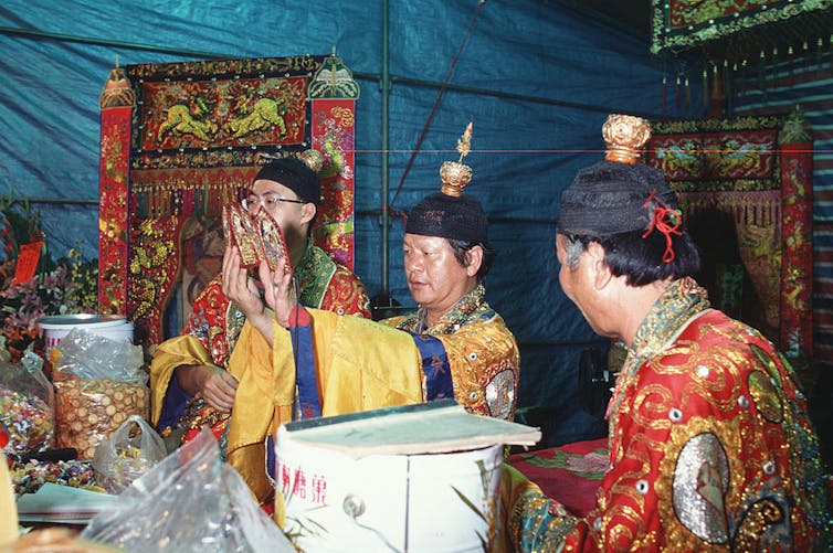 Three Priests performing ritual, photo