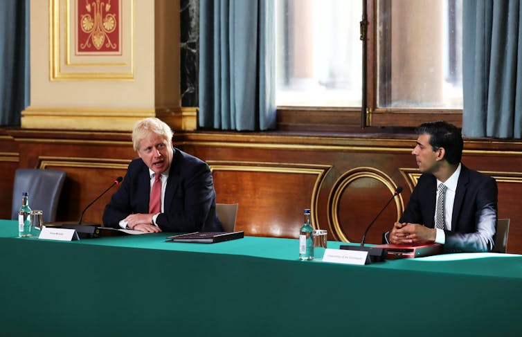 Boris Johnson and Rishi Sunak discussing cabinet business.
