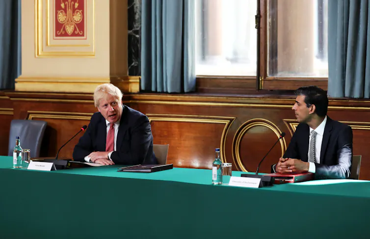 Boris Johnson and Rishi Sunak discussing cabinet business.