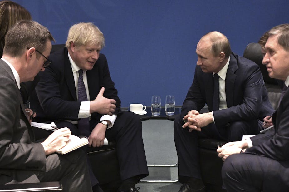 Vladimir Putin and Boris Johnson talking.