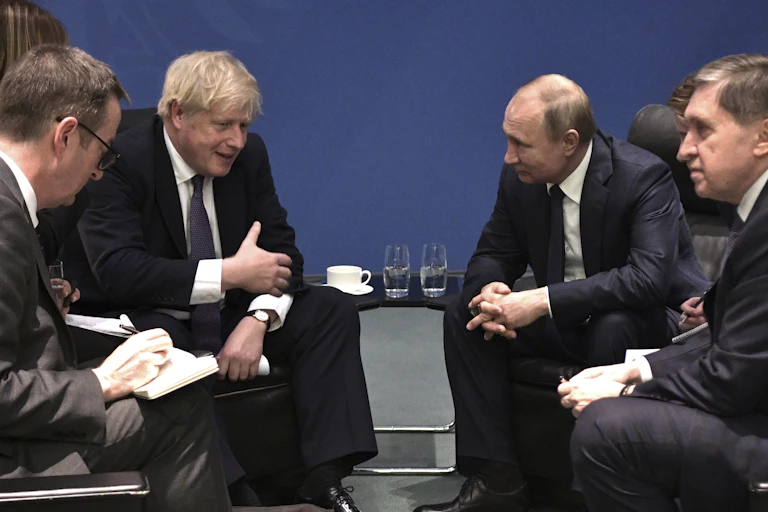 Vladimir Putin and Boris Johnson talking.