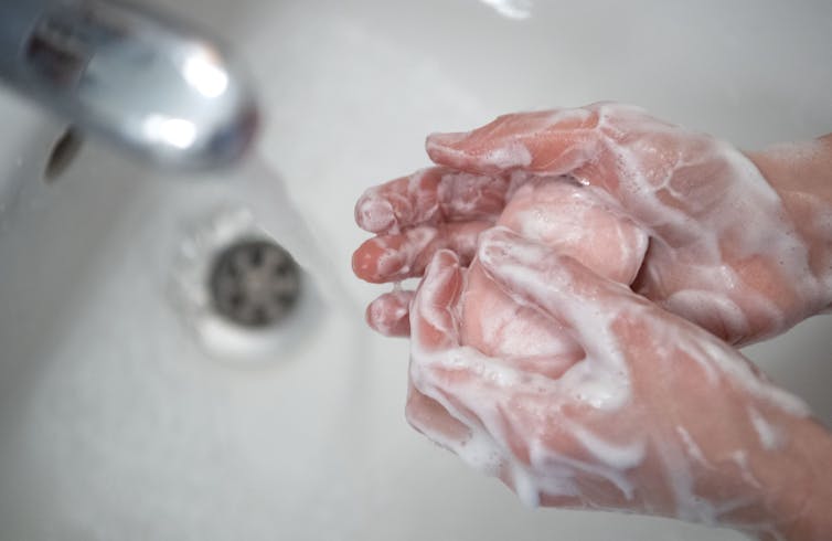 Along with wearing a mask, frequent handwashing is essential.