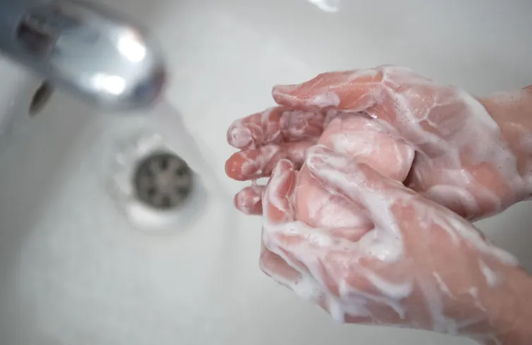 Along with wearing a mask, frequent handwashing is essential.