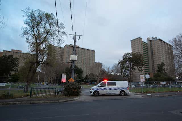 Police enforce the lockdown at public housing towers in Flemington.