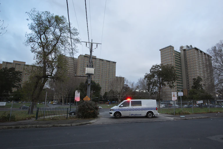Police enforce the lockdown at public housing towers in Flemington.