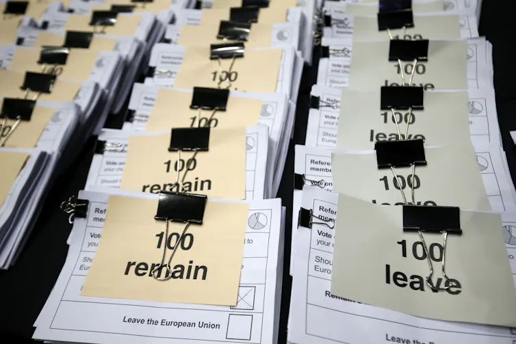 Stacks of paper votes marked Remain and Leave
