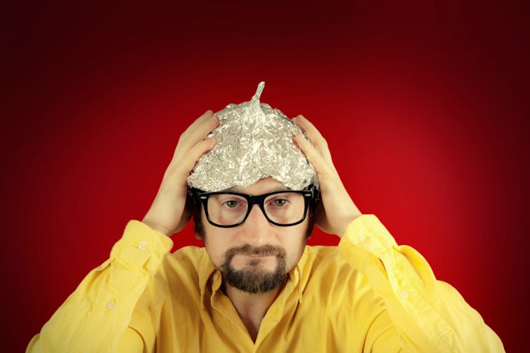 Conspiracy theorist stereotype in tinfoil hat.