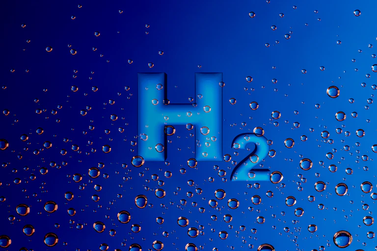 The chemical element 'H2' on a blue background with bubbles.
