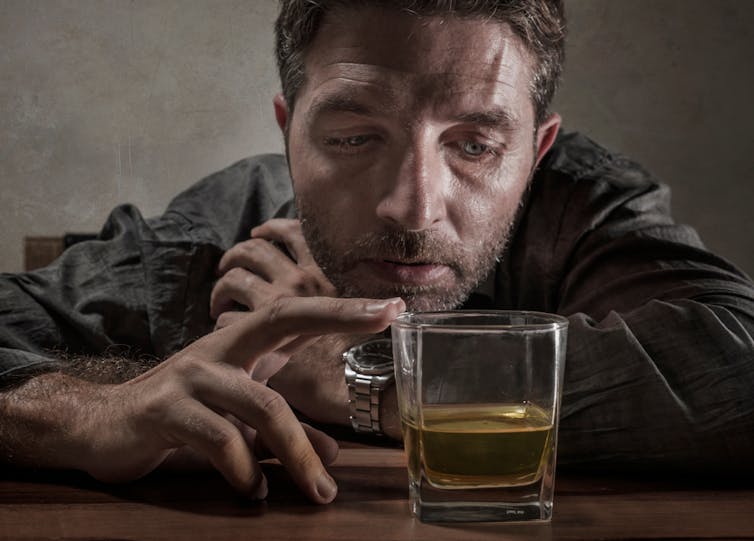 Man with whisky looking depressed