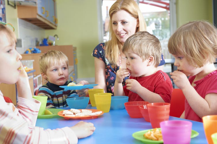 Nursery school children eating snacks