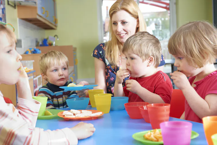 Nursery school children eating snacks