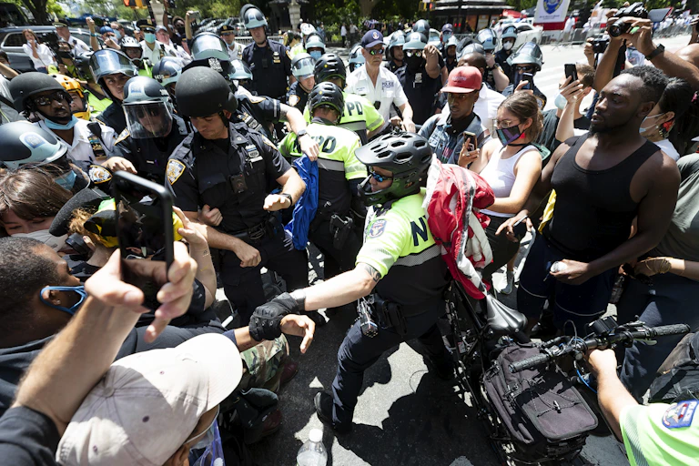 Police officer grabs Black Lives Matter protester among crowd