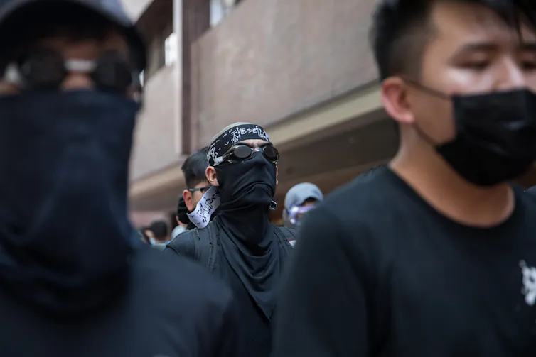 Hong Kong protesters dressed in black with face masks