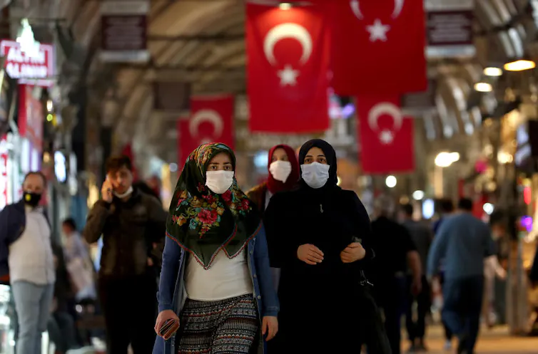 People wearing masks walking in the Grand Bazaar in Istanbul.