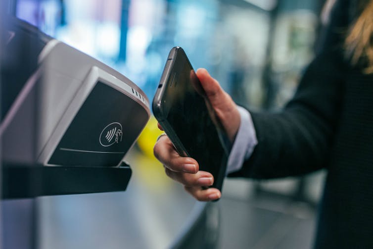 A phone being used to make a cashless payment