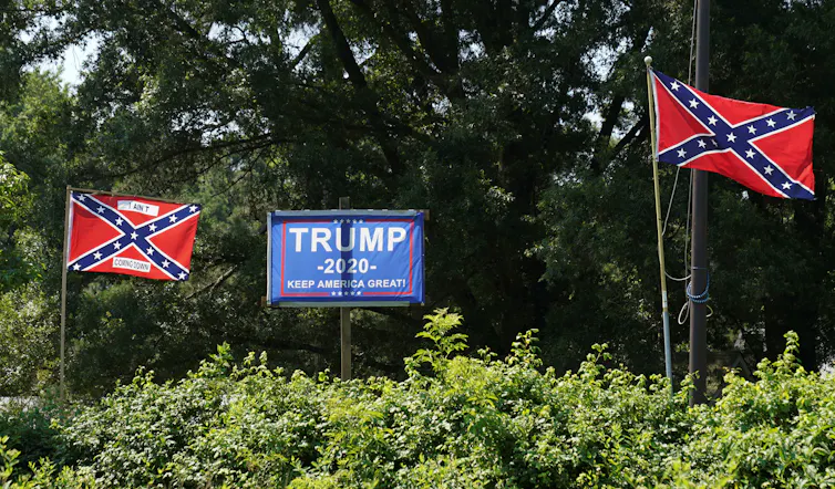 Confederate flags alongside Trump 2020 poster