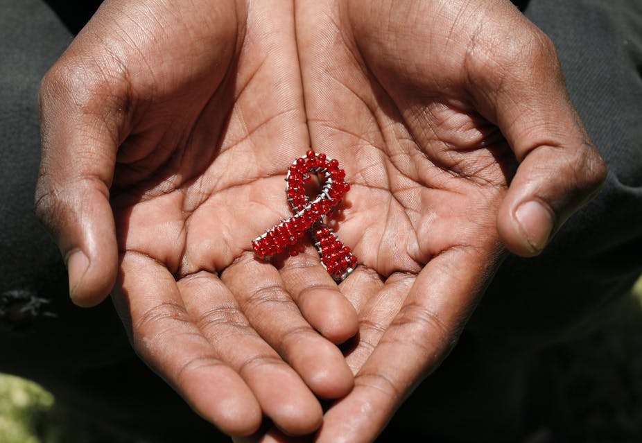 A man holding the AIDS ribbon